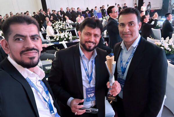 ALSALAM Electronics representatives at the TCL Global Conference 2026 in Chongqing, China, with one holding the TCL Global Excellence Award trophy.